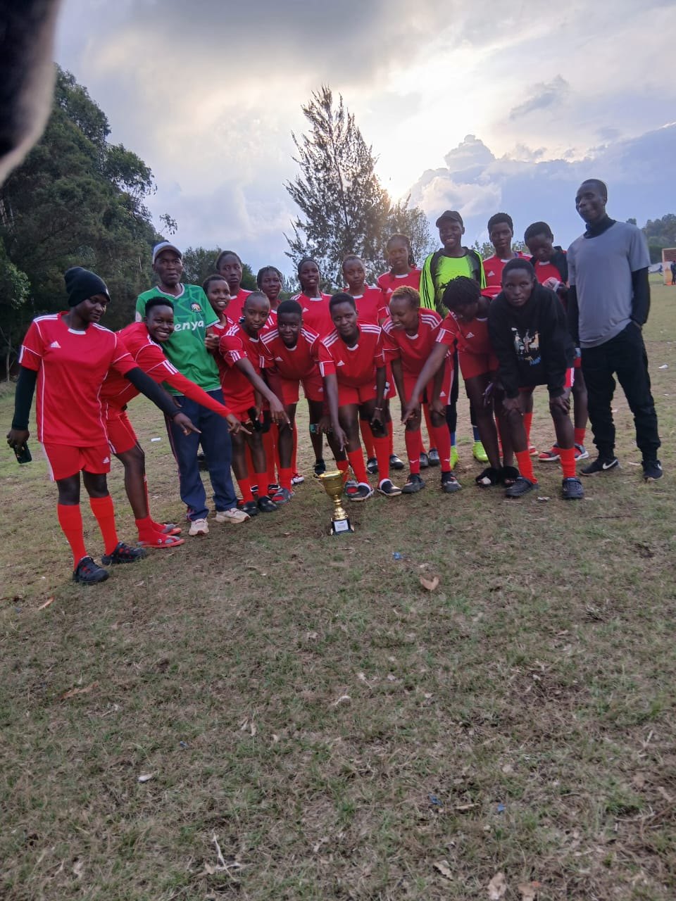 Football players and coaches gathered after a competition